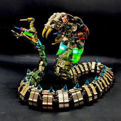 A detailed view of the articulated stinger tail of the 3D metal snake puzzle, showing its cyberpunk weapon design on a black background