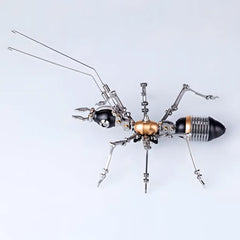Top-down view of the black and gold mechanical ant, emphasizing its highly articulated legs and long antennae.