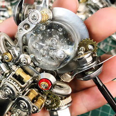 Extreme close-up of the mechanical astronaut head, showing the transparent helmet dome with simulated air bubbles and internal gear details