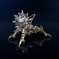 The Mechanical Spider Speaker model with blue internal light, reflecting on a black surface, emphasizing its industrial art aesthetic