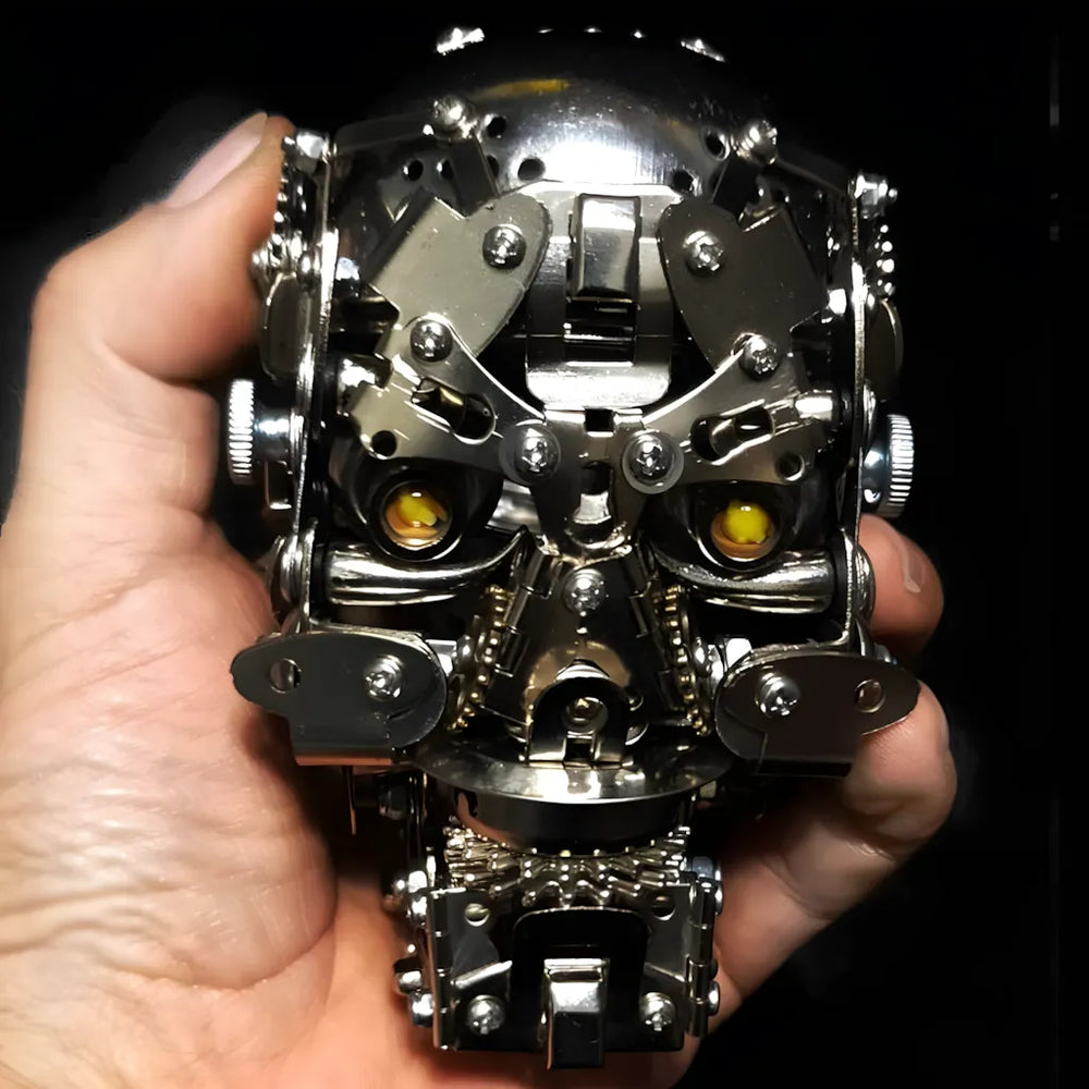 A close-up of the Cybernetic Skull head held in a hand against a dark background, highlighting its glowing yellow LED eyes.