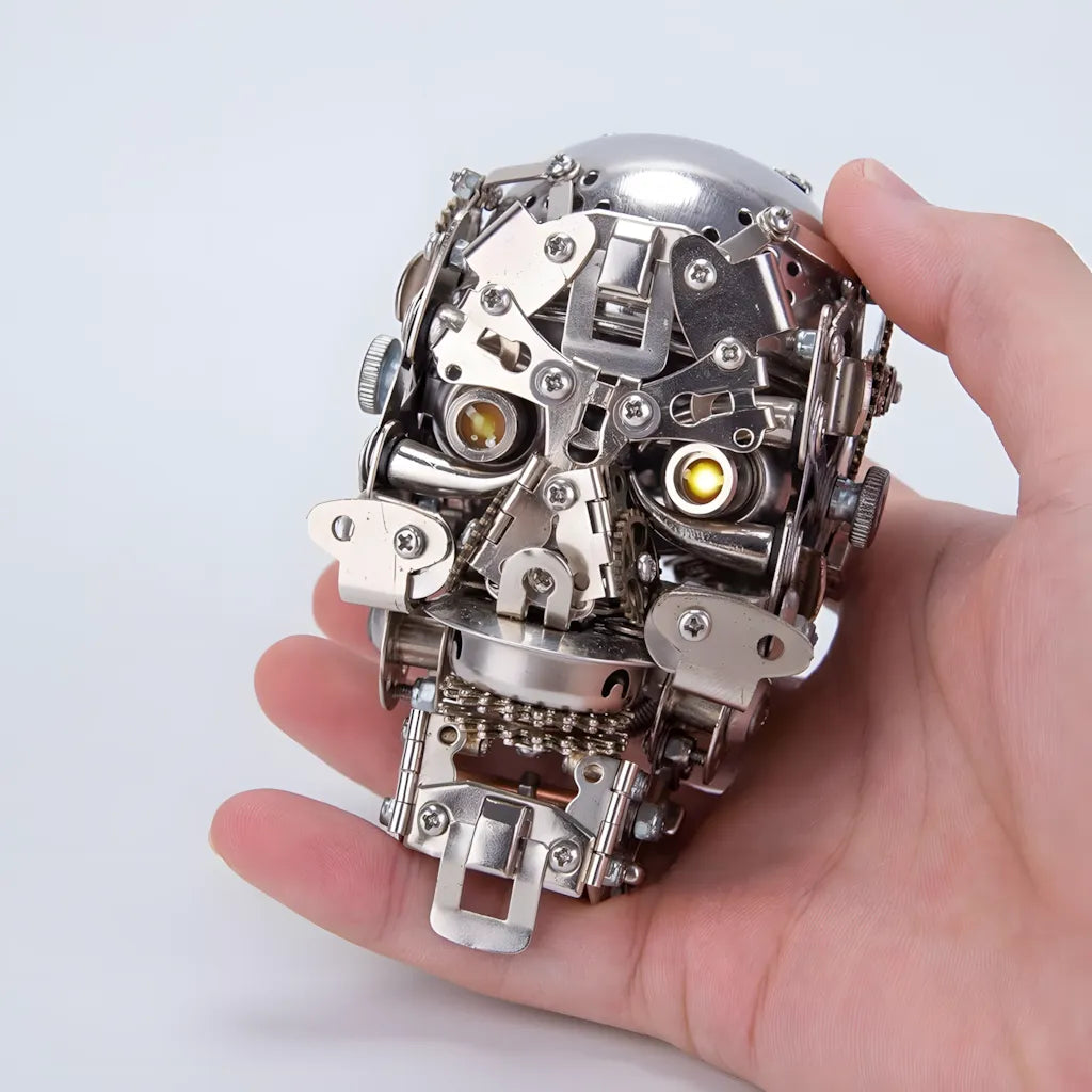 The finished Cybernetic Skull head held in a hand to clearly show the small, desk-friendly scale of the metal puzzle.