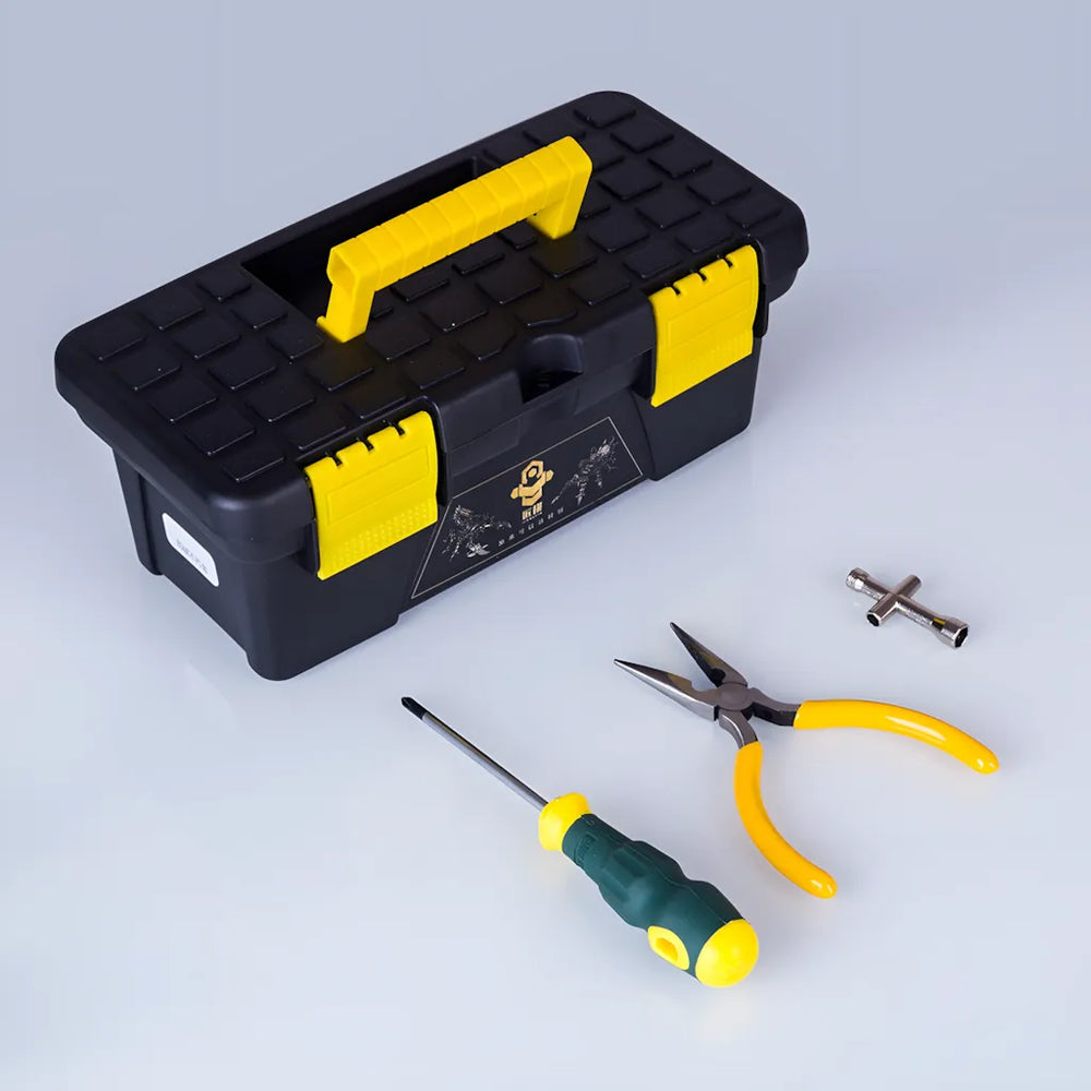 A complete set of assembly tools, including a screwdriver and pliers, placed next to the black and yellow toolkit box