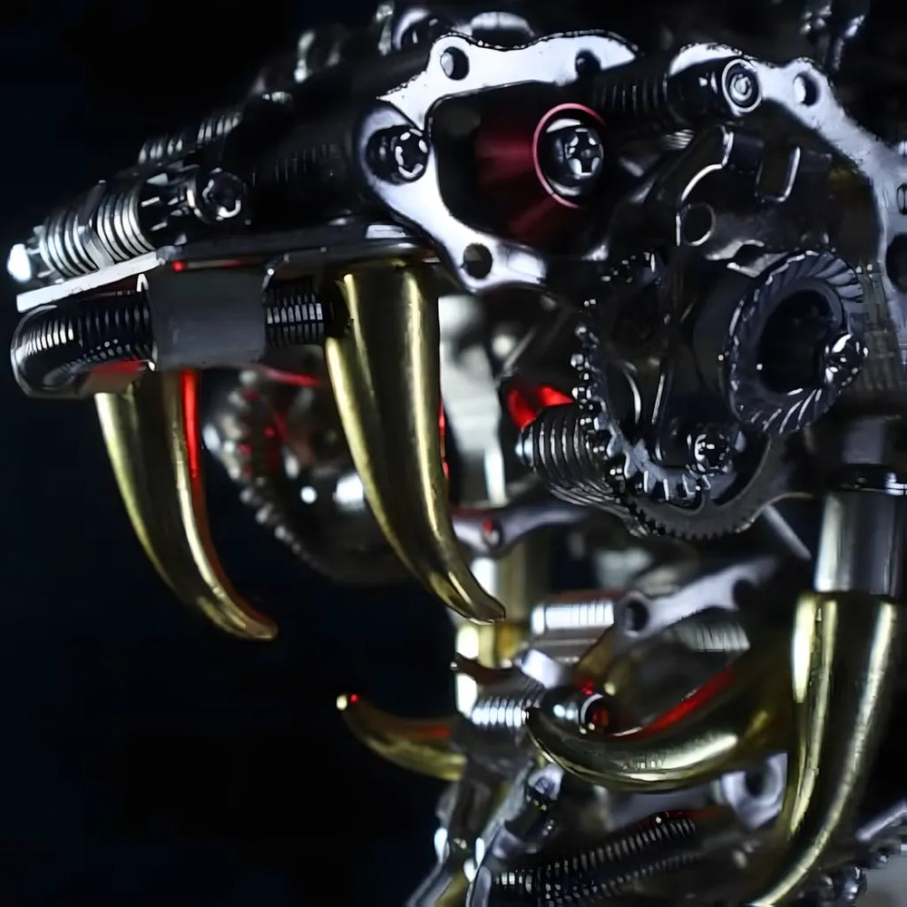 Extreme close-up macro shot of the menacing golden fangs and glowing red light inside the jaw of the Mechanical Cobra Head model