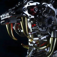 Extreme close-up macro shot of the menacing golden fangs and glowing red light inside the jaw of the Mechanical Cobra Head model