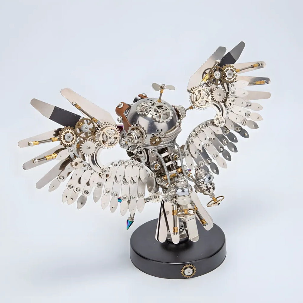 A finished Mechanical Owl metal model kit with its wings spread, shown on a white background, highlighting its metal and alloy parts