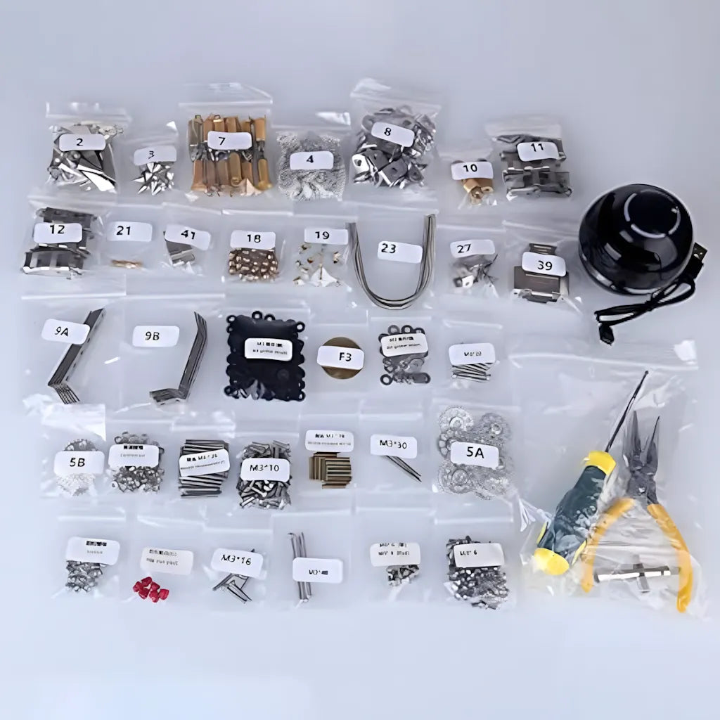 Top-down view of the comprehensive DIY kit contents, showing packaged small parts, the black 40mm speaker unit, and assembly tools