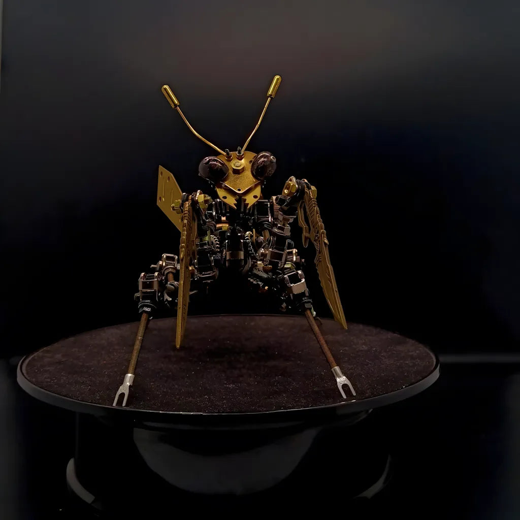 A focused front view of the mechanical mantis head, showcasing its large insect eyes and brass antennae on a black base