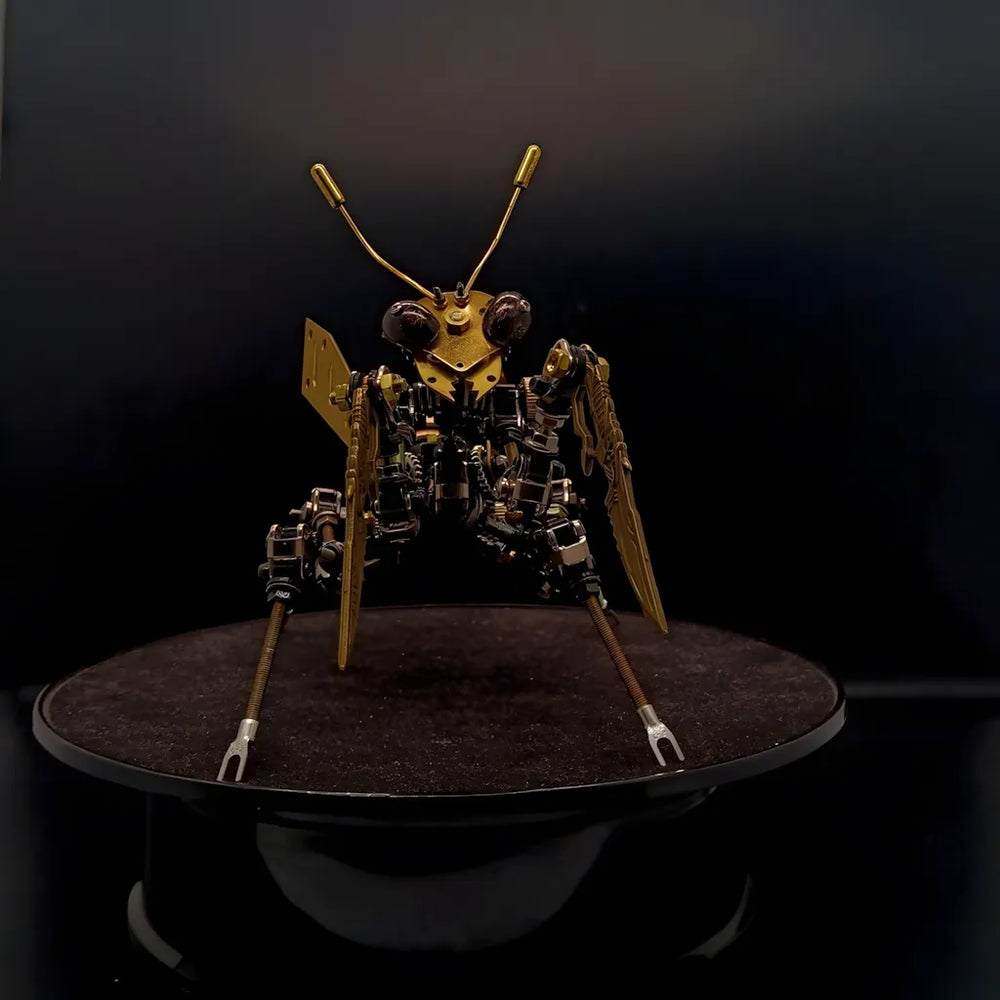 A focused front view of the mechanical mantis head, showcasing its large insect eyes and brass antennae on a black base