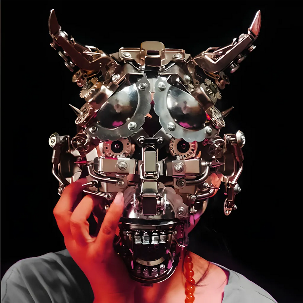 A person's hand touching the face of the menacing metal bull mask, showing its wearable nature and real-world scale